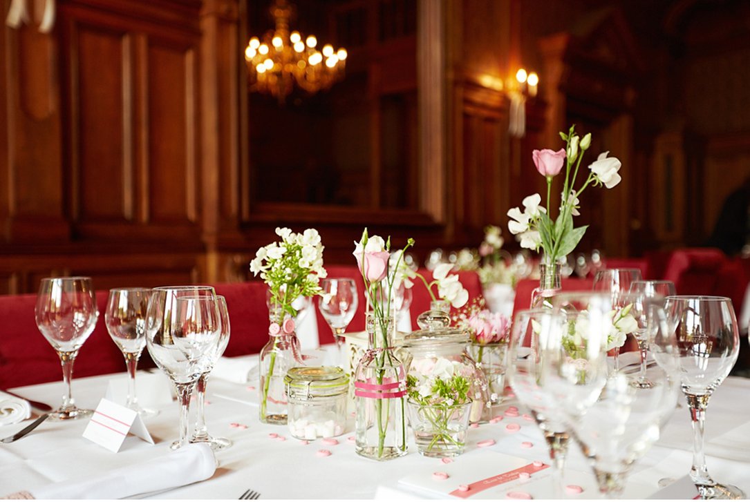 Edel dekorierter Tisch mit Gläsern und Pflanzen in einem hübschen Saal